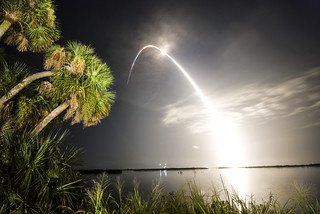 Kennedy Space Center night launch over Banana River lagoon.